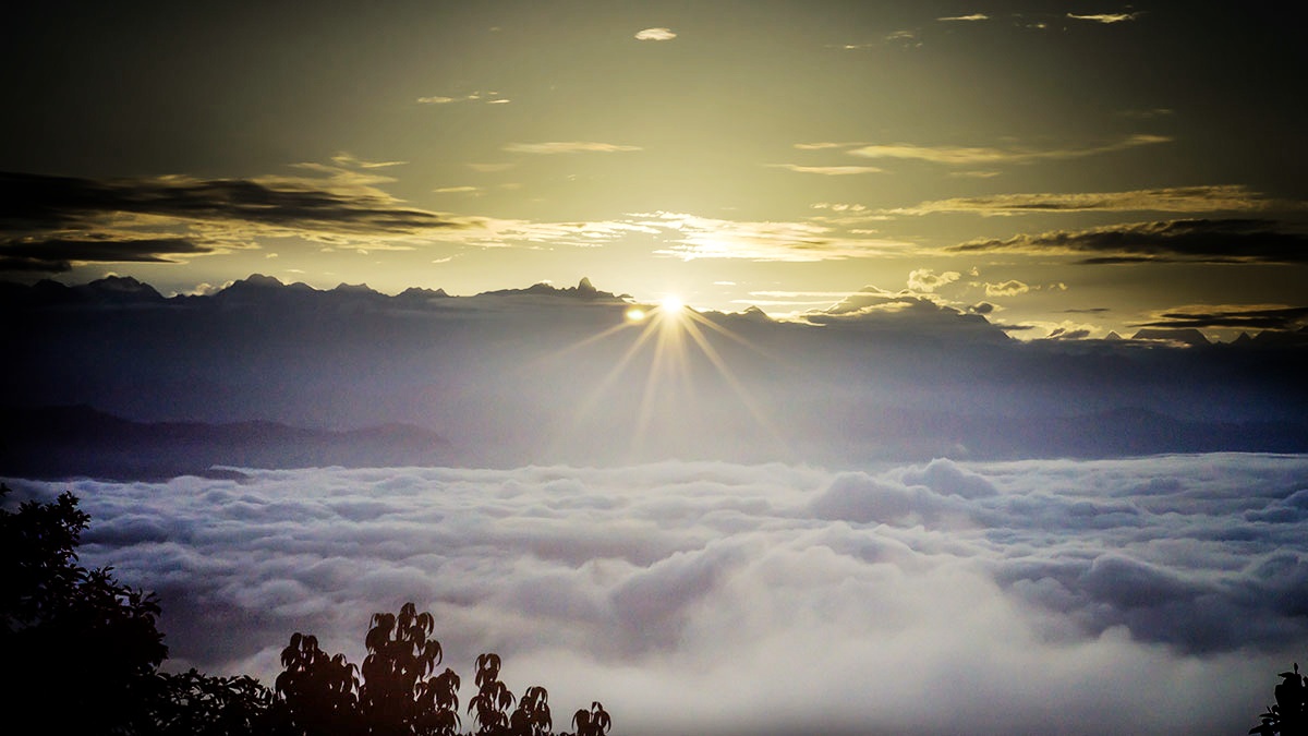 The sunrise in Nagarkot, under the clouds, with the Himalays in the background 